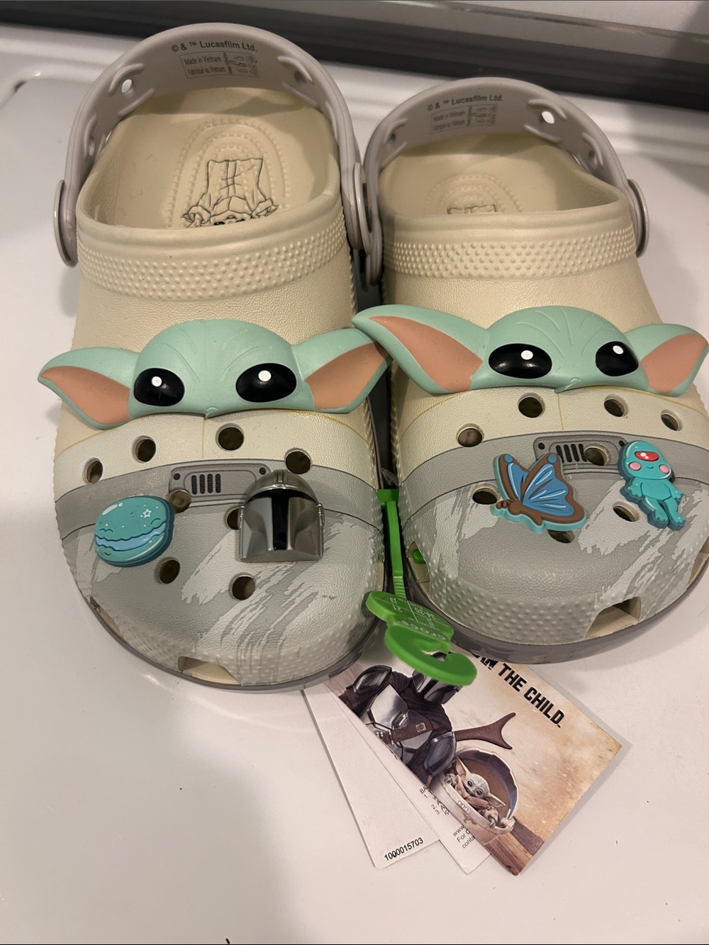 CROCS Kids Cream Clogs with Green Character Accents